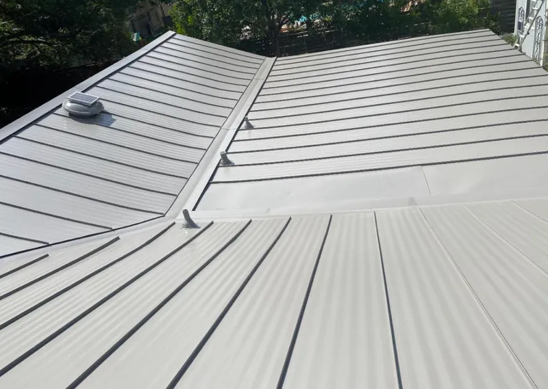 Solar attic fan installed on a metal roof for Roof Ventilation in Moline
